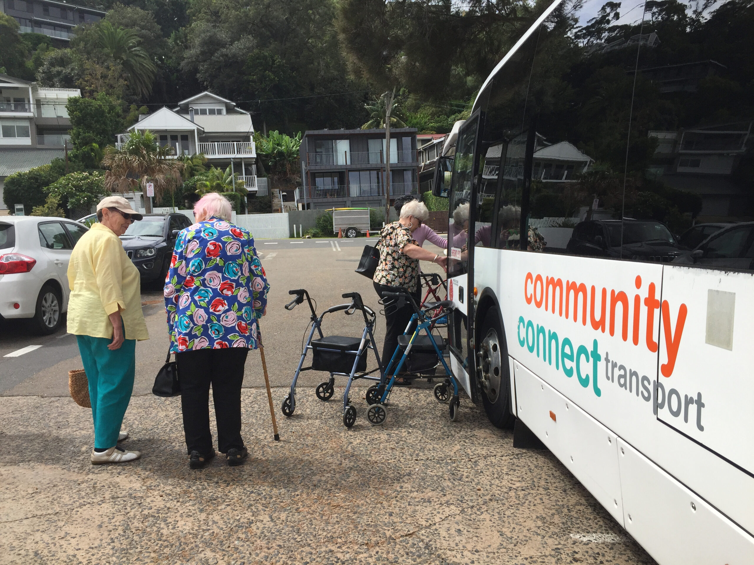 Community Connect Transport users board a bus after a trip